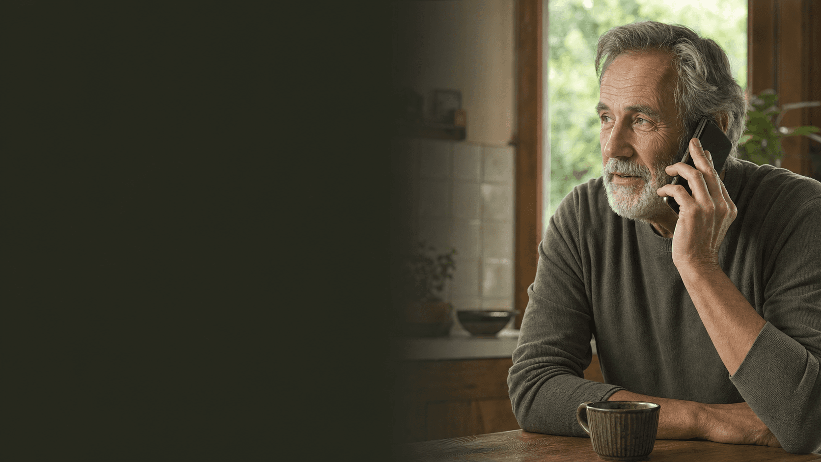 An older adult speaking naturally on the phone at home.