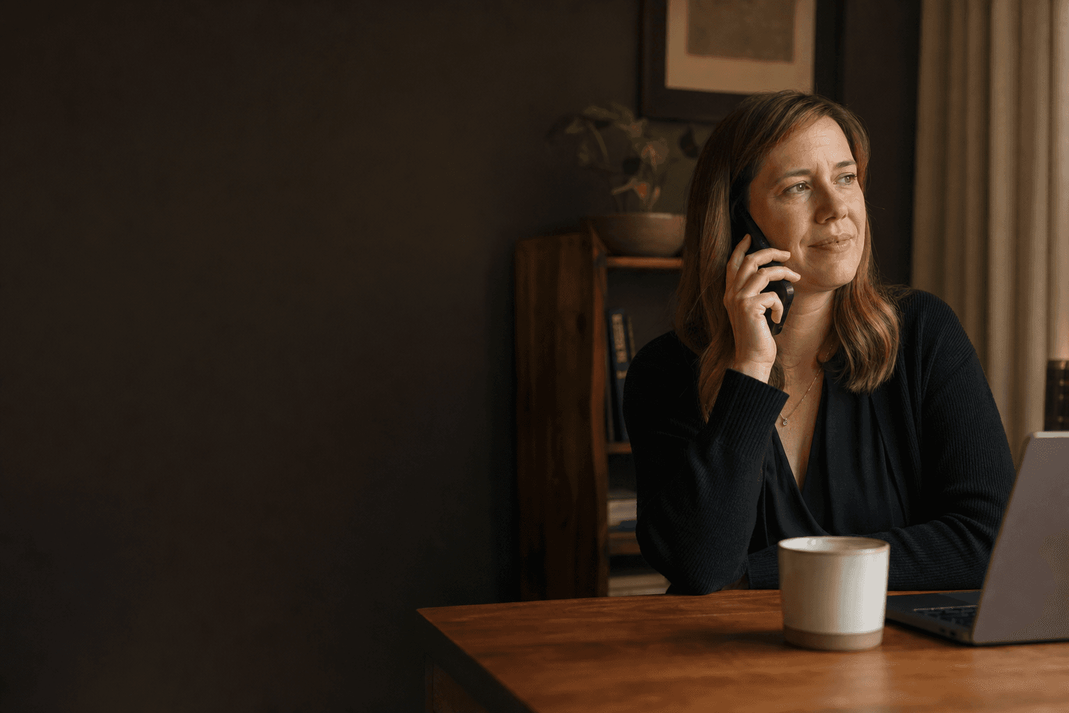 A healthcare partnerships professional having a thoughtful phone conversation.
